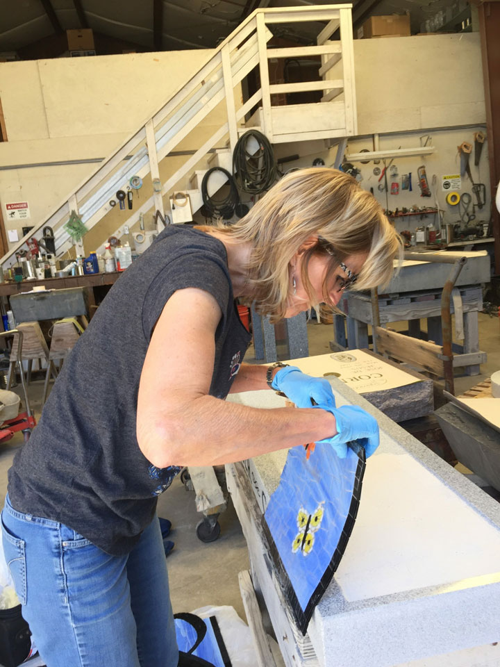 Marsha working on a butterfly mosaic tile